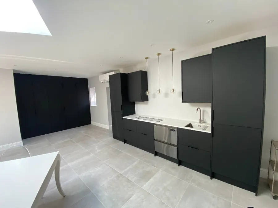 Wide view of black bar with matching storage wall